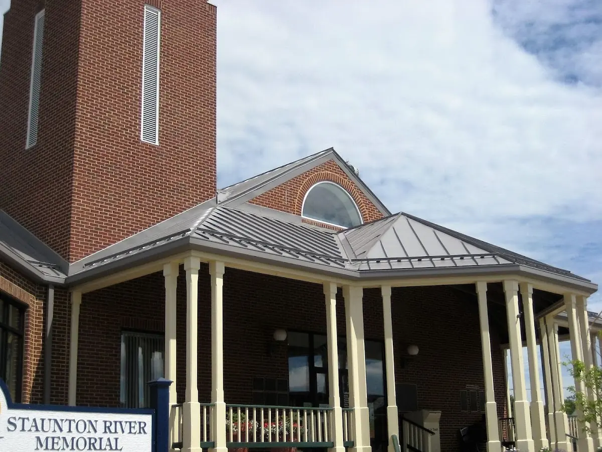 Skilled roofing craftsmen working on a residential roof in Monroe